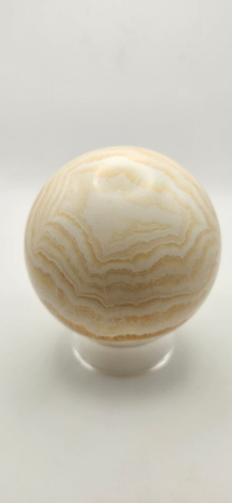 Orange calcite sphere. 72.5mm, 2.85 inches, 1.3 pounds