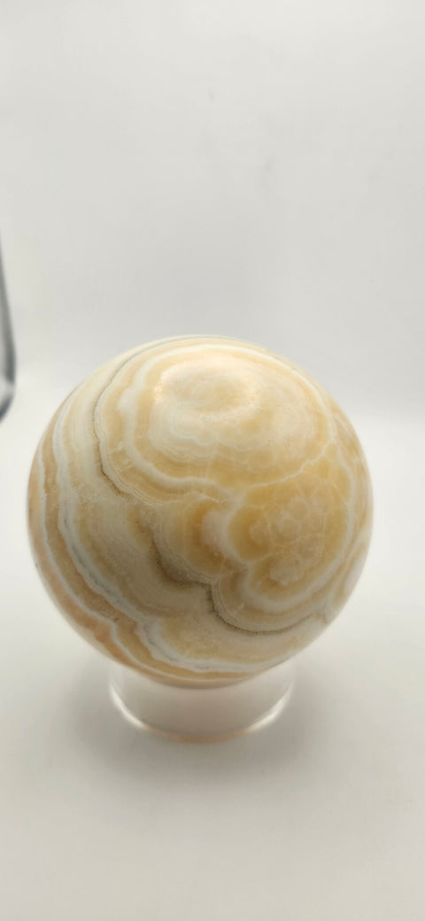 Orange calcite sphere. 72.5mm, 2.85 inches, 1.3 pounds