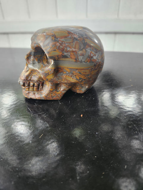 Fruit jasper skull. 15 ounces, 3.5 inches wide, 2.75 inches long