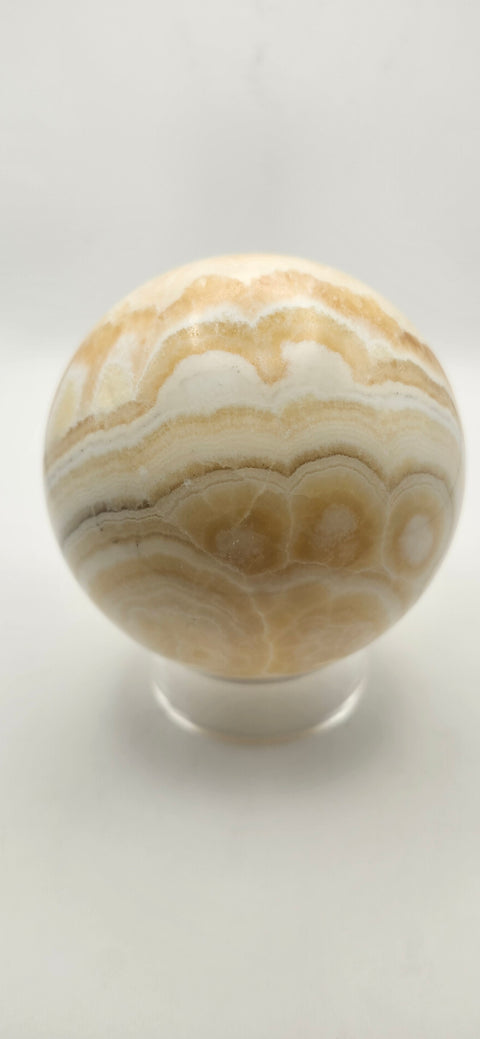 Orange calcite sphere. 72.5mm, 2.85 inches, 1.3 pounds