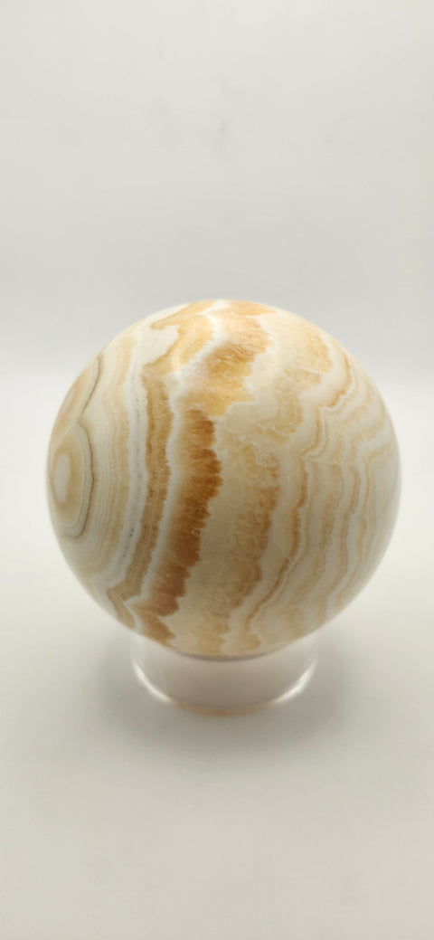 Orange calcite sphere. 72.5mm, 2.85 inches, 1.3 pounds