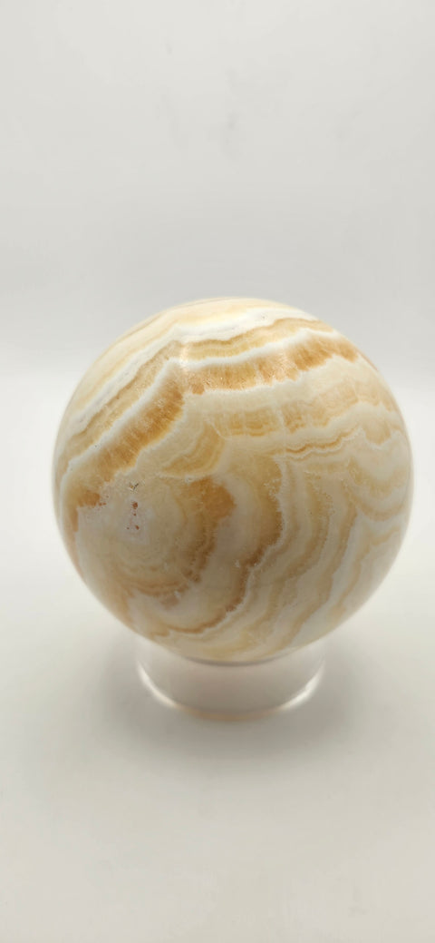 Orange calcite sphere. 72.5mm, 2.85 inches, 1.3 pounds