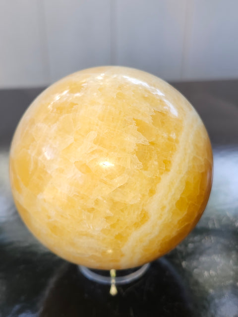 Orange calcite sphere! 73.6mm, 2.9 inches, 1.4 pounds