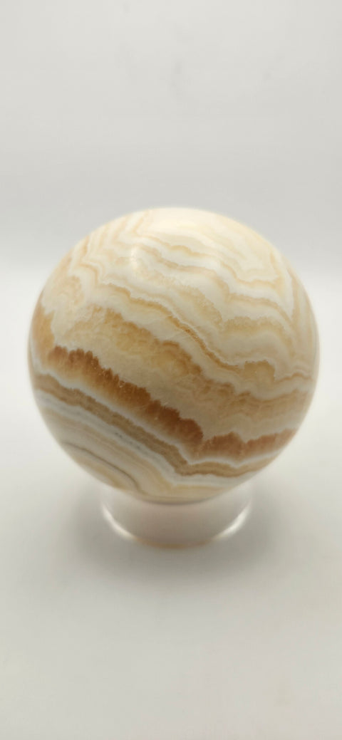 Orange calcite sphere. 72.5mm, 2.85 inches, 1.3 pounds