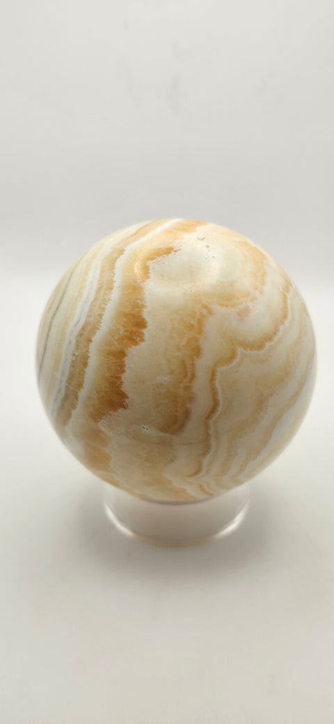 Orange calcite sphere. 72.5mm, 2.85 inches, 1.3 pounds