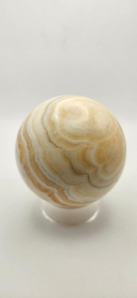 Orange calcite sphere. 72.5mm, 2.85 inches, 1.3 pounds