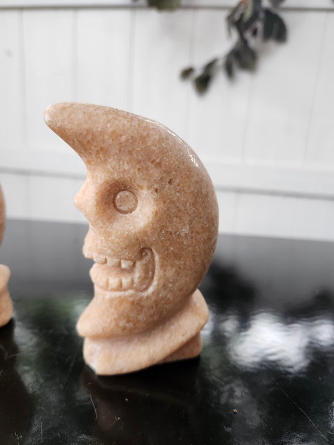 7.4 ounce orange calcite skull faced moon carving! 4 inches