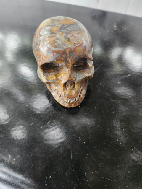 Fruit jasper skull. 15 ounces, 3.5 inches wide, 2.75 inches long