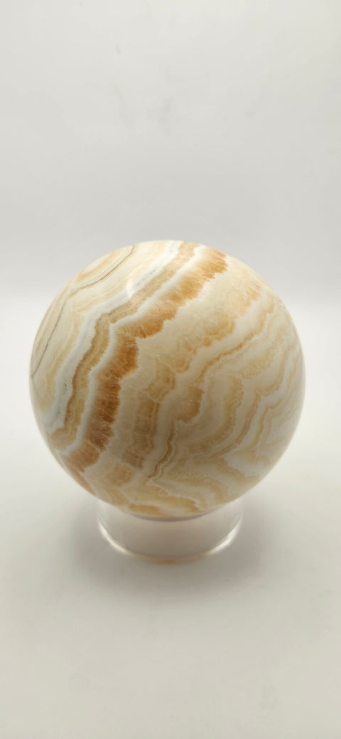 Orange calcite sphere. 72.5mm, 2.85 inches, 1.3 pounds