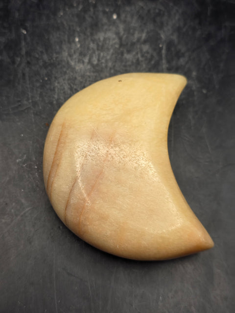 Orange calcite moon! 5.8 ounces, 2.8 inches long, 1.7 inches wide