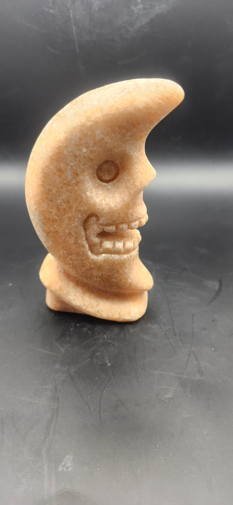 Orange calcite skull faced moon!! 7.2 ounces, 4 inches tall