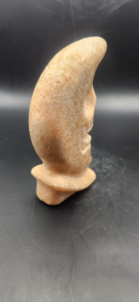 Orange calcite skull faced moon!! 7.2 ounces, 4 inches tall
