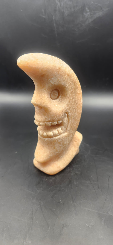 Orange calcite skull faced moon!! 7.2 ounces, 4 inches tall