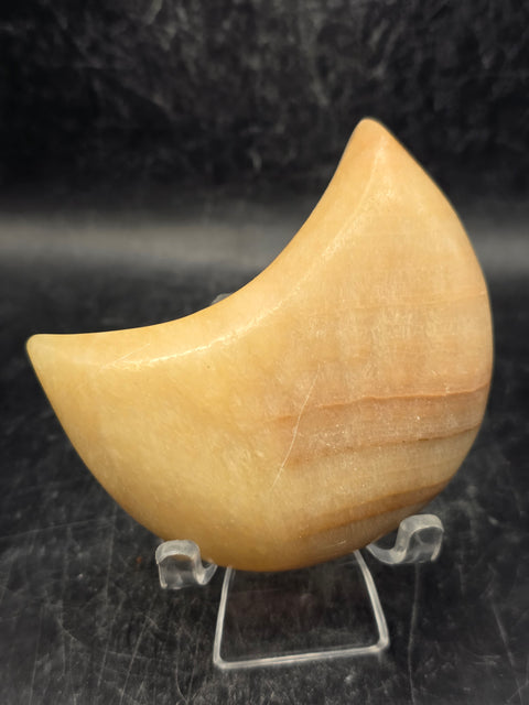 Orange calcite moon! 5.8 ounces, 2.8 inches long, 1.7 inches wide