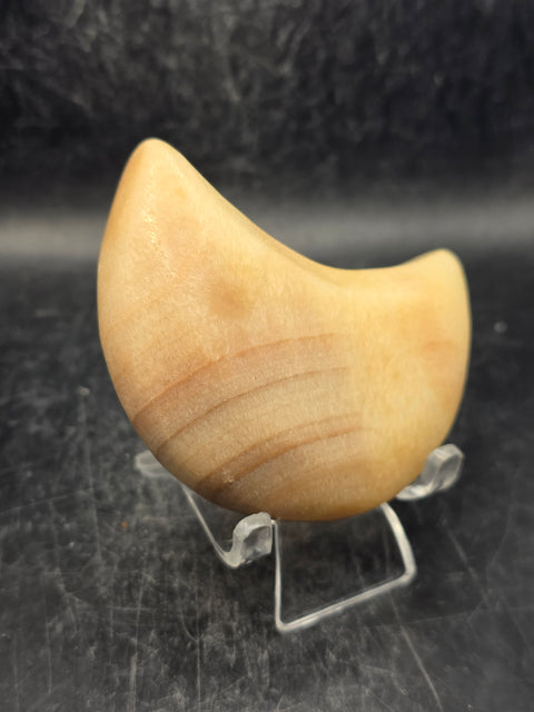 Orange calcite moon! 5.8 ounces, 2.8 inches long, 1.7 inches wide