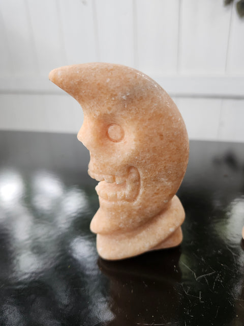 7.4 ounce orange calcite skull faced moon carving! 4 inches