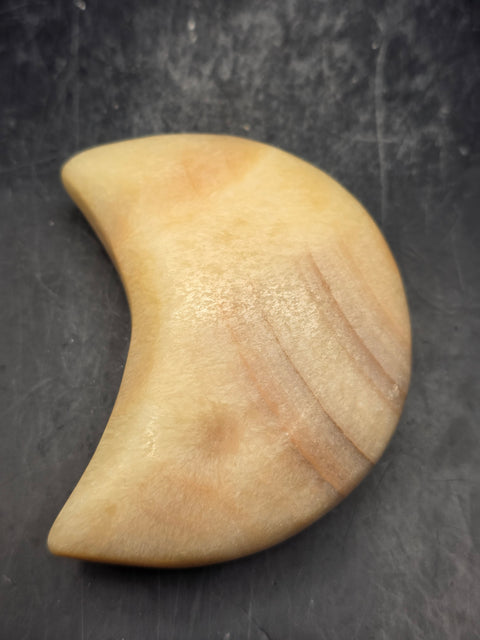 Orange calcite moon! 5.8 ounces, 2.8 inches long, 1.7 inches wide