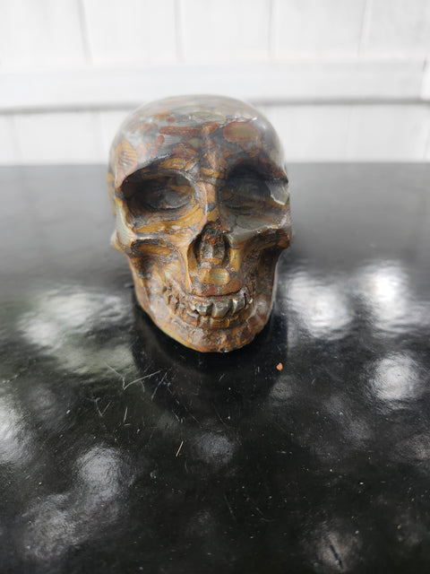 Fruit jasper skull. 15 ounces, 3.5 inches wide, 2.75 inches long