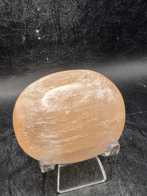 Peach selenite palm stone! 2.5 inches wide, 3 ounces